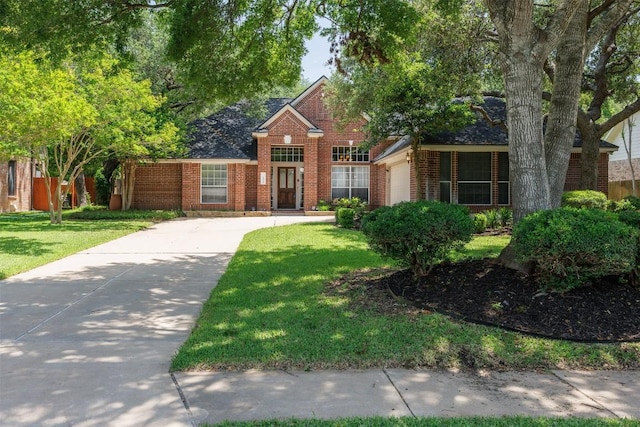 2025 Saint Andrews Dr, Round Rock, TX 78664 - traditional-style home with brick siding, an attached garage, a front lawn, and driveway