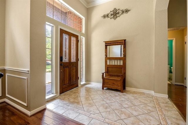 2025 Saint Andrews Dr, Round Rock, TX 78664 - entryway with crown molding, baseboards, light wood-type flooring, and a high ceiling