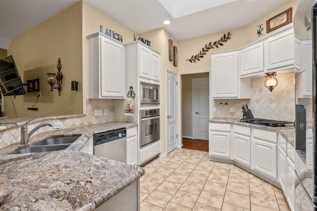 2025 Saint Andrews Dr, Round Rock, TX 78664 - kitchen with a sink, appliances with stainless steel finishes, recessed lighting, light stone countertops, and tasteful backsplash