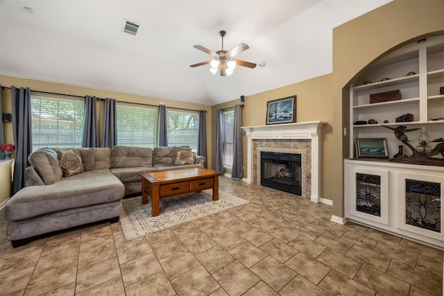 2025 Saint Andrews Dr, Round Rock, TX 78664 - living area with a ceiling fan, healthy amount of natural light, a fireplace, lofted ceiling, and built in shelves