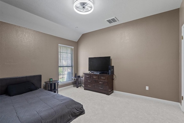 2025 Saint Andrews Dr, Round Rock, TX 78664 - bedroom with light carpet, lofted ceiling, baseboards, and a textured wall