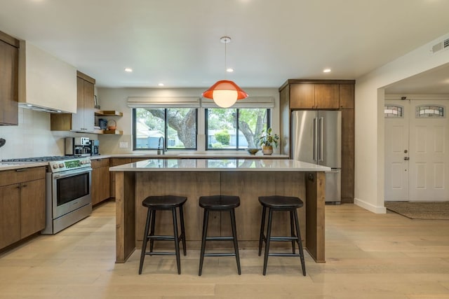 11602 Barrington Way, Austin, TX 78759 - kitchen featuring stainless steel appliances, a sink, a kitchen breakfast bar, a center island, and open shelves