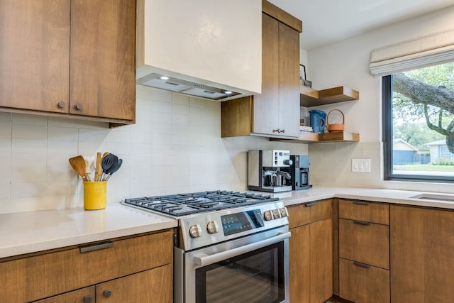 11602 Barrington Way, Austin, TX 78759 - kitchen with stainless steel gas range oven, decorative backsplash, and light countertops