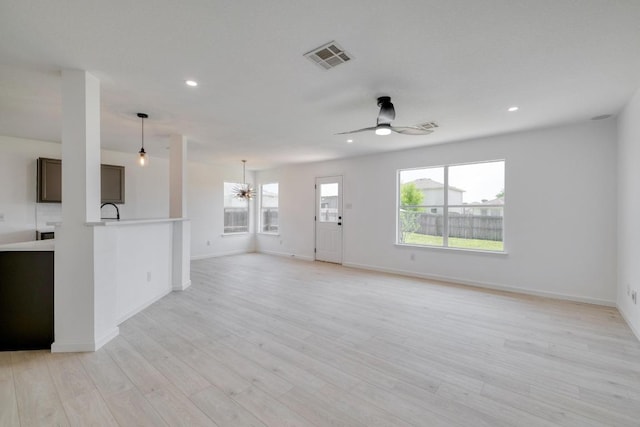 303 Flinn St, Hutto, TX 78634 - unfurnished living room with ceiling fan, recessed lighting, baseboards, a chandelier, and light wood-type flooring