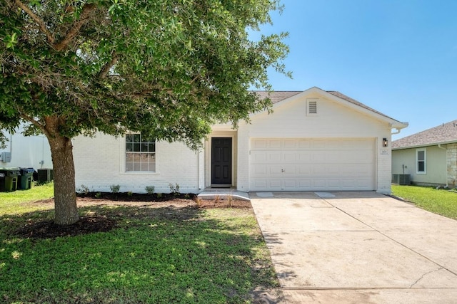 303 Flinn St, Hutto, TX 78634 - view of front of property with brick siding, an attached garage, concrete driveway, a front lawn, and central AC