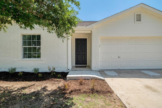 303 Flinn St, Hutto, TX 78634 - view of front of property with brick siding, an attached garage, and concrete driveway