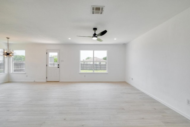 303 Flinn St, Hutto, TX 78634 - unfurnished room featuring a chandelier, light wood-style flooring, baseboards, ceiling fan, and recessed lighting