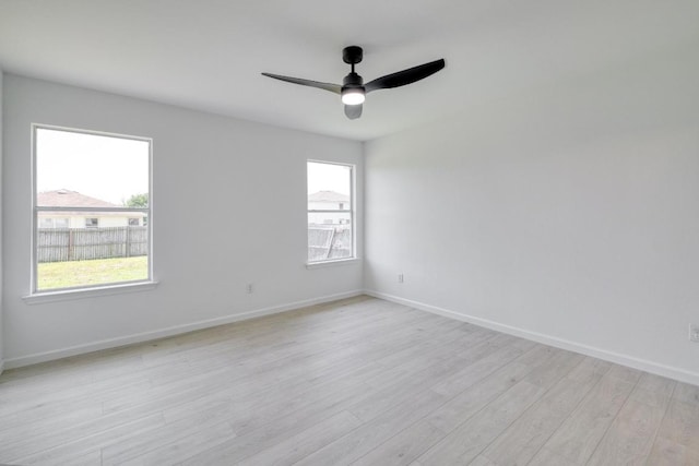 303 Flinn St, Hutto, TX 78634 - spare room featuring a ceiling fan, light wood-style flooring, and baseboards