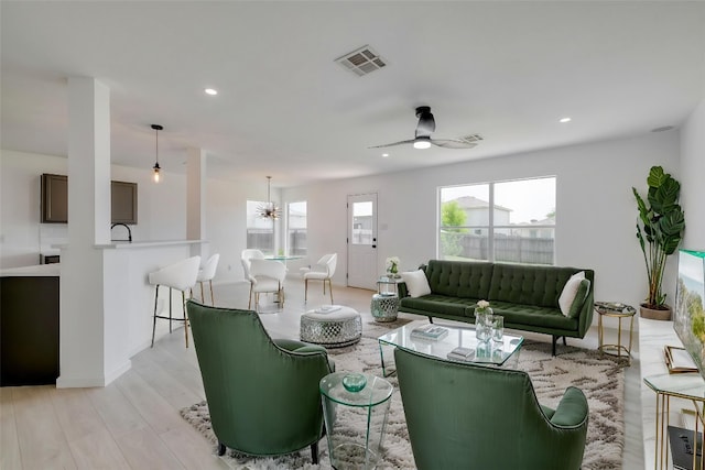 303 Flinn St, Hutto, TX 78634 - living room with ceiling fan, recessed lighting, light wood-style flooring, and a chandelier
