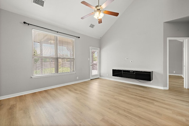 unfurnished living room featuring a ceiling fan, high vaulted ceiling, light wood-style floors, and baseboards
