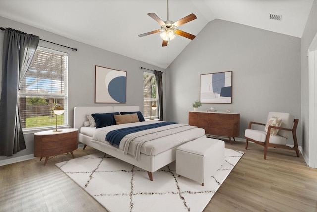 bedroom featuring high vaulted ceiling, baseboards, a ceiling fan, and light wood-type flooring