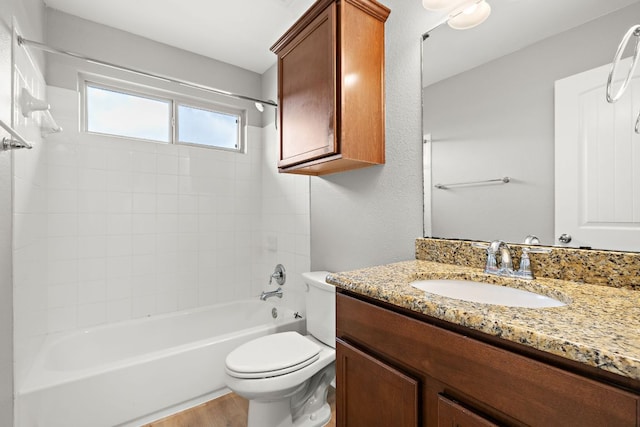 full bathroom featuring toilet, vanity, tub / shower combination, and wood finished floors