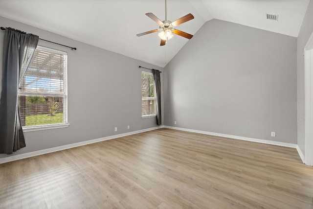empty room with ceiling fan, light wood-style flooring, high vaulted ceiling, and baseboards