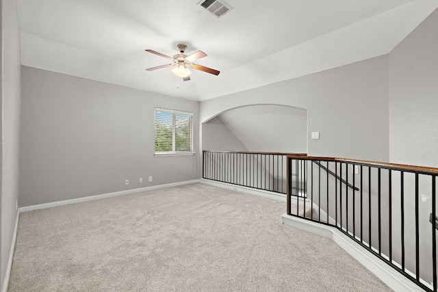 spare room with ceiling fan, carpet floors, baseboards, and lofted ceiling