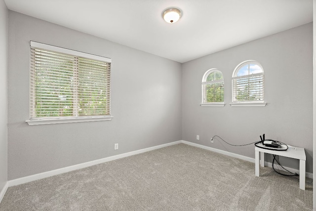 spare room with carpet floors and baseboards