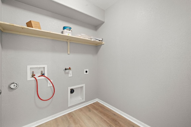 washroom featuring gas dryer hookup, electric dryer hookup, light wood-type flooring, hookup for a washing machine, and baseboards