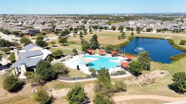 aerial view of residential area featuring a large body of water and a pool