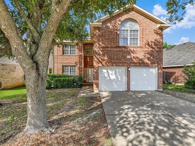 traditional home featuring brick siding, concrete driveway, and an attached garage