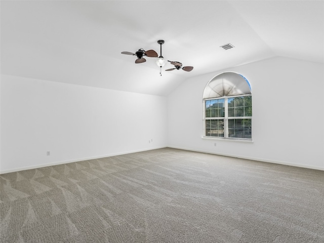 unfurnished room featuring vaulted ceiling, carpet floors, ceiling fan, and baseboards