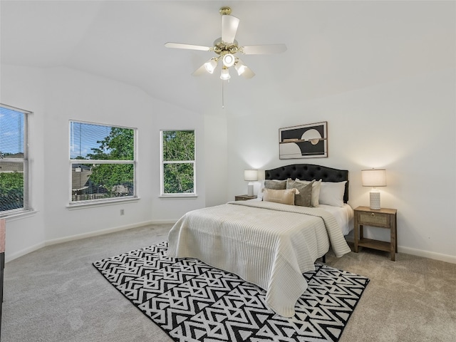 bedroom featuring carpet floors, multiple windows, vaulted ceiling, baseboards, and ceiling fan