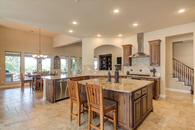 kitchen with wall chimney range hood, dishwasher, recessed lighting, a kitchen island, and backsplash