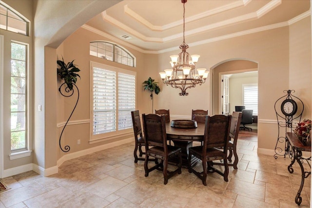 3920 Vail Dv, Bee Cave, TX 78738 - dining room featuring arched walkways, stone tile floors, healthy amount of natural light, and ornamental molding