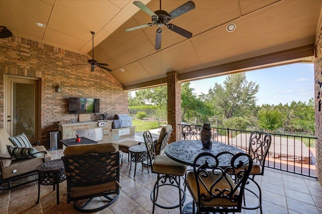 view of patio / terrace featuring exterior kitchen, ceiling fan, area for grilling, outdoor lounge area, and outdoor dining area