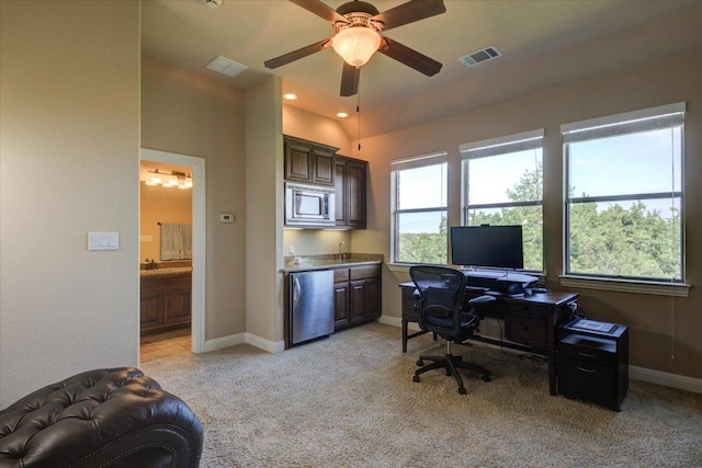 office space featuring ceiling fan, light colored carpet, and baseboards