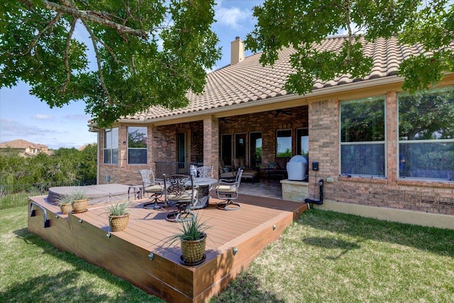 wooden deck with outdoor dining space and a yard