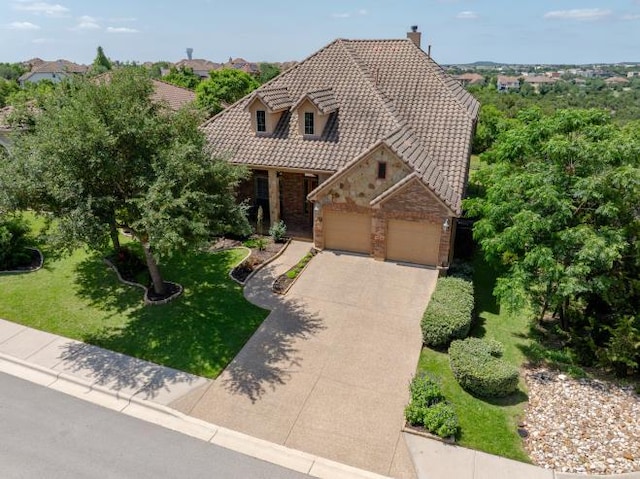 3920 Vail Dv, Bee Cave, TX 78738 - view of front of home with stone siding, a chimney, a tile roof, driveway, and a front lawn