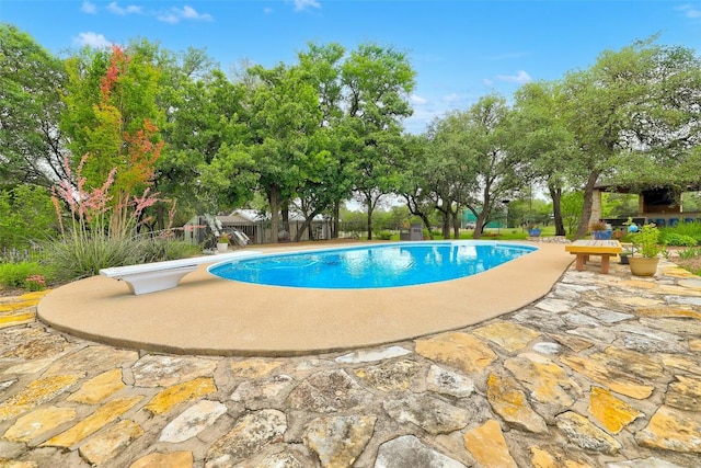 9840 N Live Oak Rd, Salado, TX 76571 - outdoor pool with a patio area, a diving board, and fence