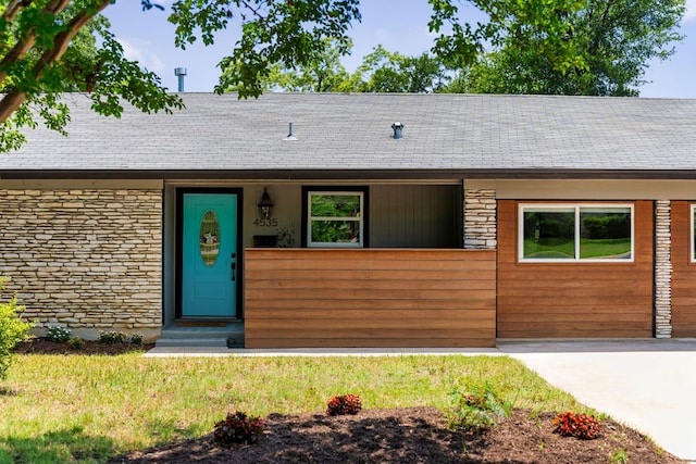 4535 Pack Saddle Pass, Austin, TX 78745 - view of front facade featuring stone siding and a shingled roof