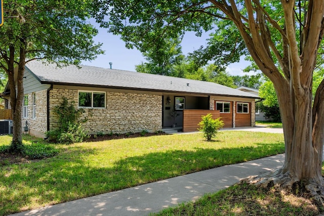 4535 Pack Saddle Pass, Austin, TX 78745 - ranch-style house featuring stone siding, central AC unit, and a front yard
