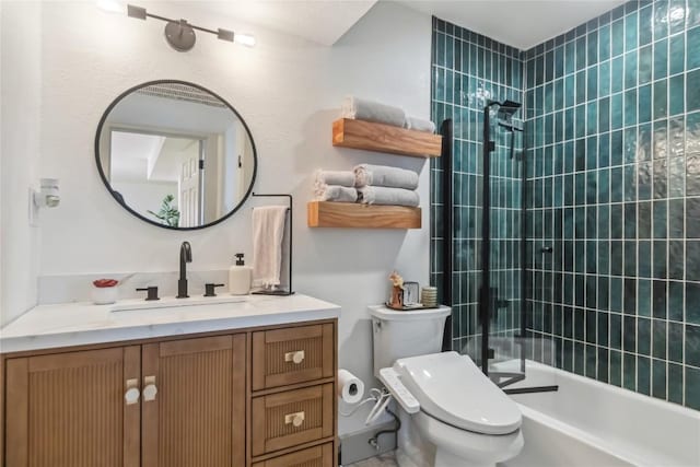 full bathroom with tiled shower, toilet, and vanity
