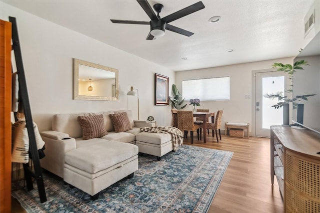 living room with a ceiling fan, light wood-style flooring, and recessed lighting