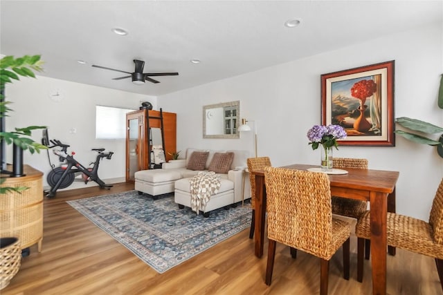 dining room featuring wood finished floors, a ceiling fan, and recessed lighting