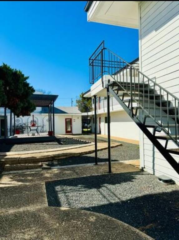 view of side of home featuring stairs