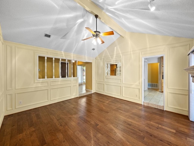 3606 Spotted Horse Trl, Austin, TX 78739 - unfurnished living room featuring a decorative wall, wood finished floors, a ceiling fan, and a textured ceiling