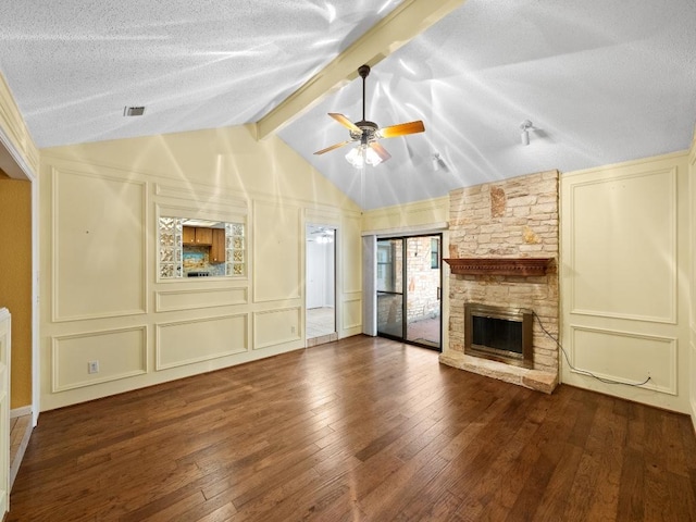 3606 Spotted Horse Trl, Austin, TX 78739 - unfurnished living room with a decorative wall, wood-type flooring, a textured ceiling, a ceiling fan, and a fireplace