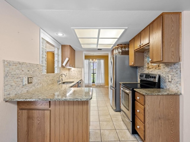 3606 Spotted Horse Trl, Austin, TX 78739 - kitchen with electric stove, decorative backsplash, light tile patterned flooring, light stone counters, and a peninsula