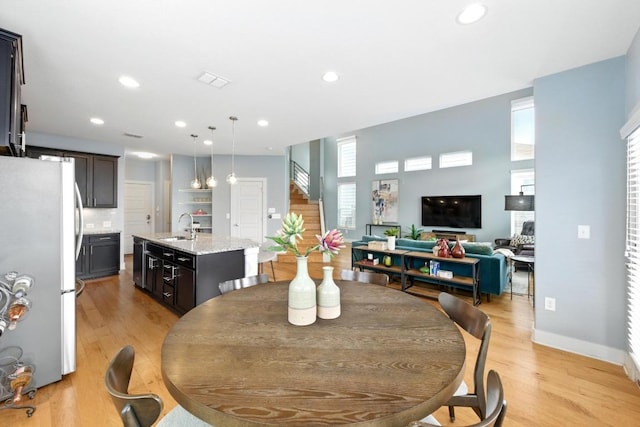 7308 Oberon St, Austin, TX 78741 - dining space featuring light wood-type flooring, recessed lighting, and baseboards
