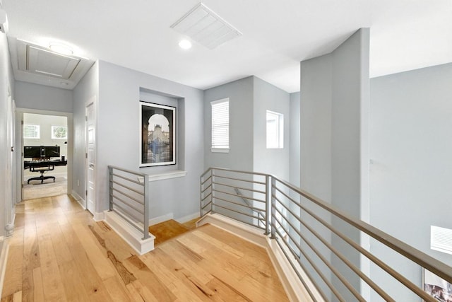 7308 Oberon St, Austin, TX 78741 - hallway featuring an upstairs landing, attic access, light wood-style floors, baseboards, and recessed lighting