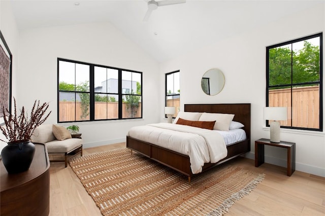 1703 Madison Ave, Austin, TX 78757 - bedroom featuring light wood-type flooring, high vaulted ceiling, baseboards, and ceiling fan