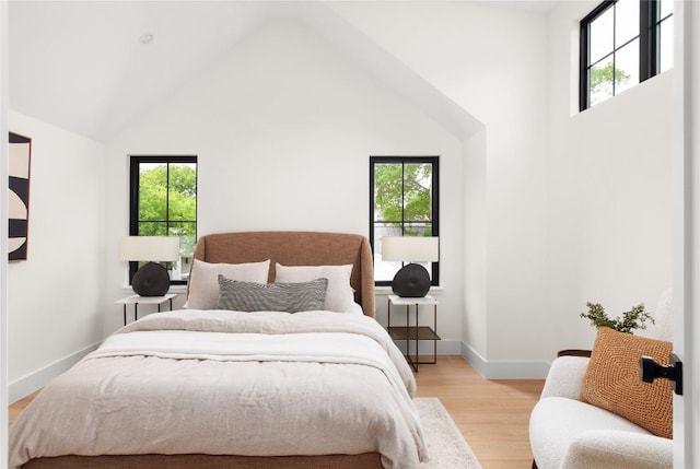 1703 Madison Ave, Austin, TX 78757 - bedroom with multiple windows, light wood-style flooring, baseboards, and high vaulted ceiling