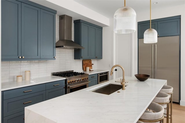 1703 Madison Ave, Austin, TX 78757 - kitchen with wall chimney range hood, high end appliances, a sink, a kitchen breakfast bar, and tasteful backsplash
