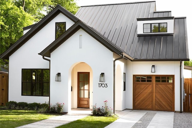 1703 Madison Ave, Austin, TX 78757 - modern inspired farmhouse featuring stucco siding, an attached garage, metal roof, and driveway