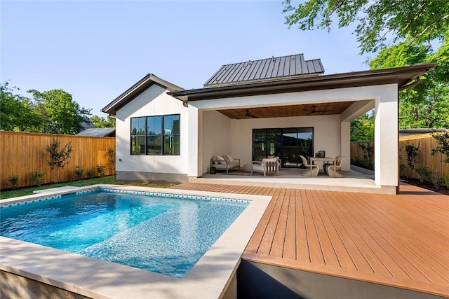 1703 Madison Ave, Austin, TX 78757 - back of house with ceiling fan, a fenced backyard, a wooden deck, and stucco siding