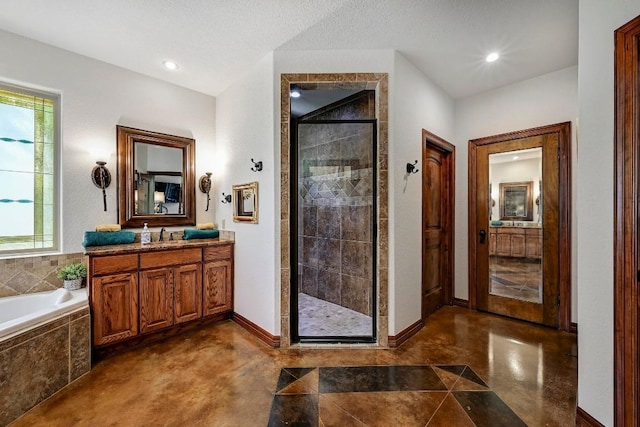 2600 Grapevine Springs Cv, Georgetown, TX 78628 - full bathroom with a shower stall, vanity, a garden tub, concrete flooring, and baseboards