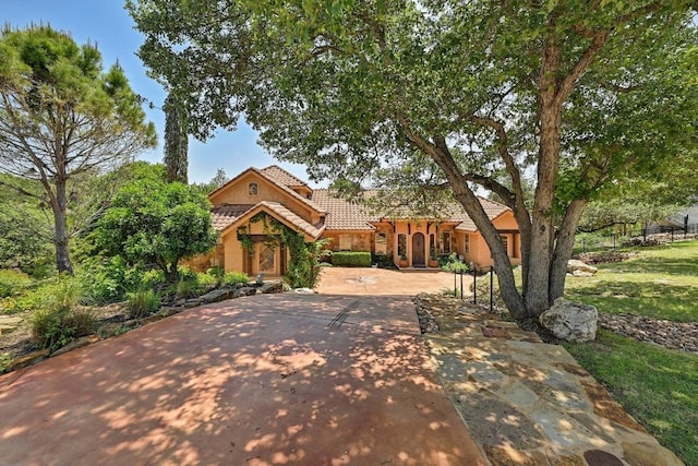 2600 Grapevine Springs Cv, Georgetown, TX 78628 - mediterranean / spanish home featuring a tile roof, stucco siding, and driveway