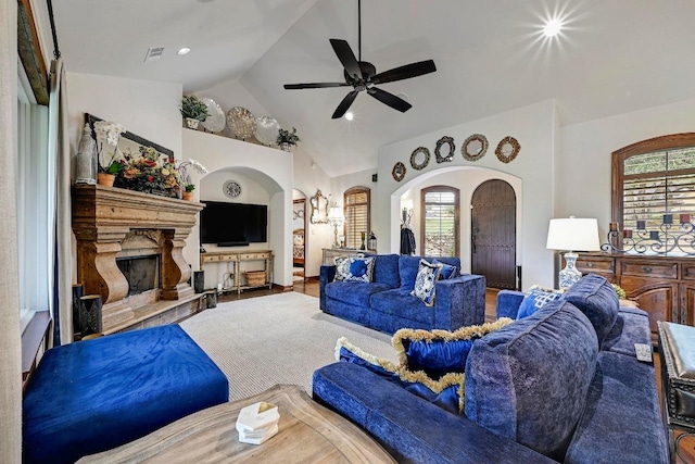 2600 Grapevine Springs Cv, Georgetown, TX 78628 - living room with arched walkways, ceiling fan, lofted ceiling, and a fireplace with raised hearth